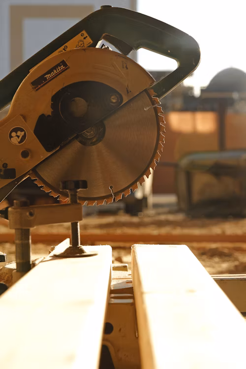 A circular saw cutting through a length of timber